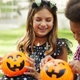 Kids looking in trick or treat buckets on halloween